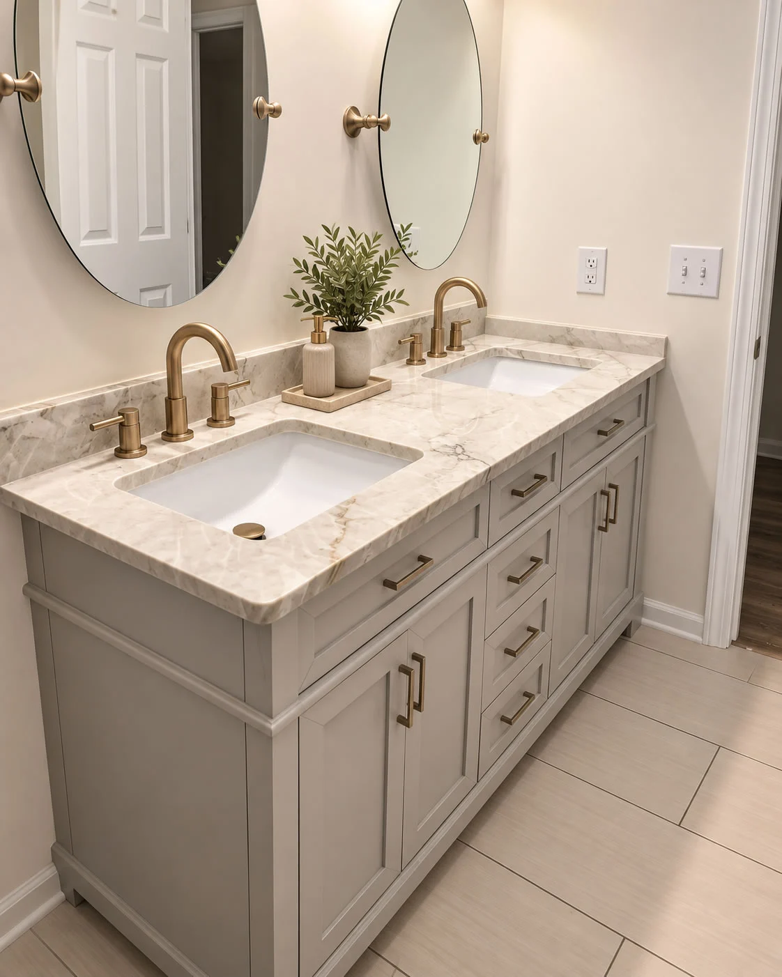 Bathroom featuring natural stone vanity countertops and double sinks